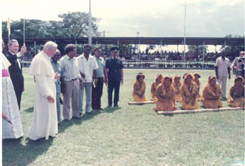 Pope John Paul II greeted by topless native women