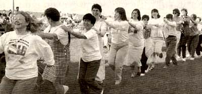 A photograph of religious sisters having a 'line dance' at a conference in Chicago
