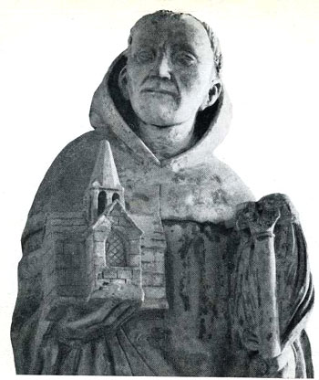 A statue of St. Bernard holding a miniature Abbey of Clairvaux