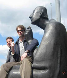 A youth sits on a modern art sculpture of St. Albert