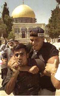Jewish guard restrains an Arab