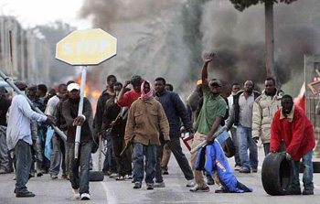 young immigrant men rioting in Rosarno, Calabria