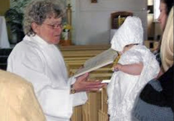 sister Thiffault administers baptism to an infant