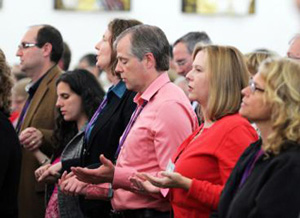 Catholics praying and holding hands