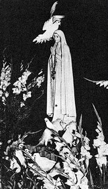 Black and white photo of a statue of Our Lady with doves flying around it