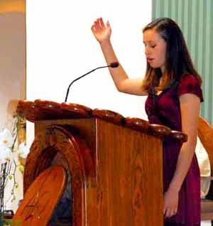 A Woman cantor directing singing