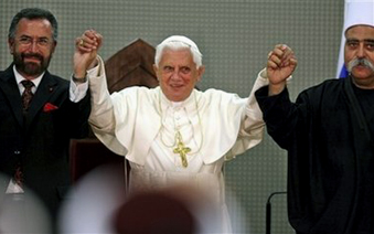 Benedict joining hands with a rabbi and a mufti